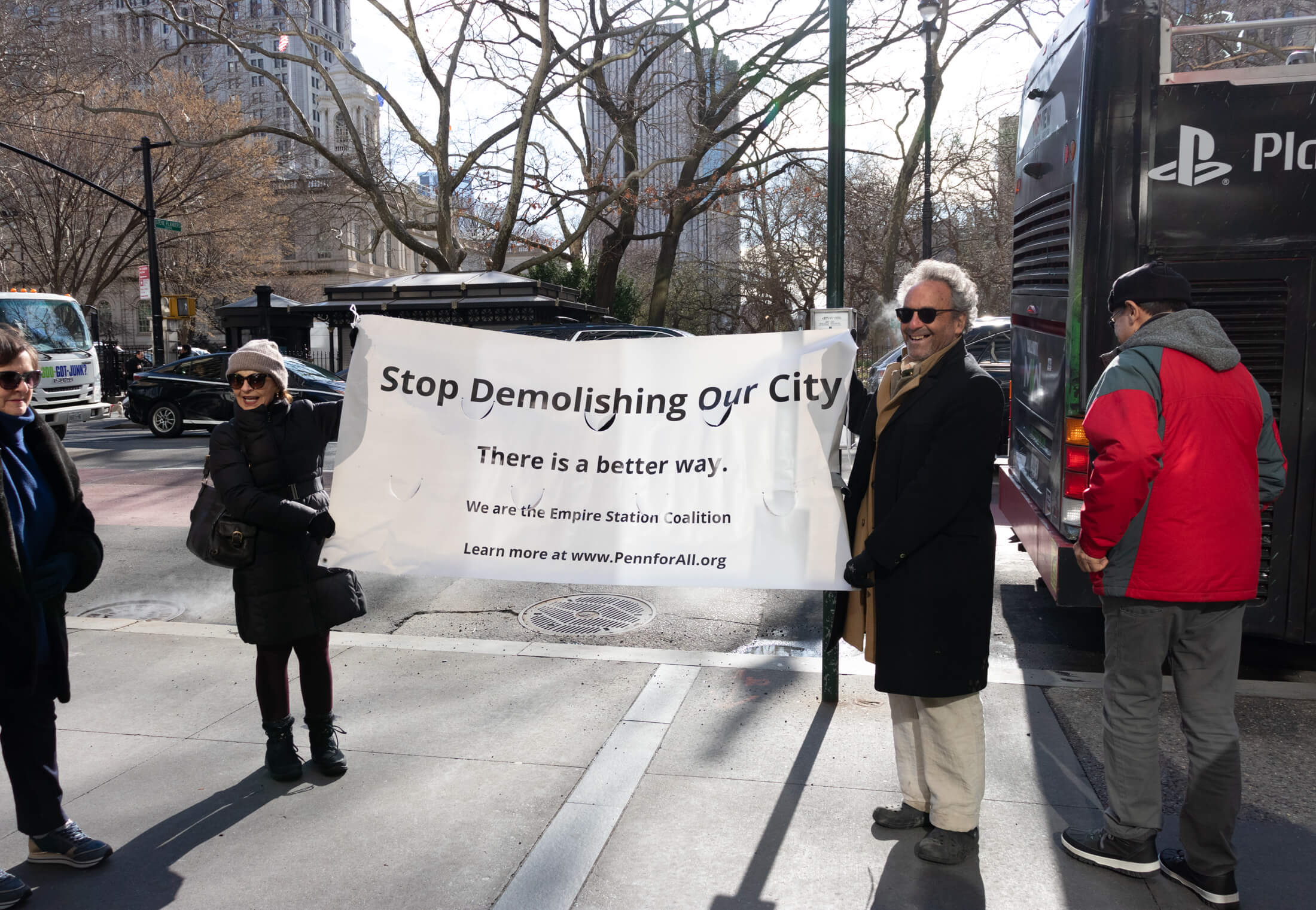 two people at the event holding up a banner from the Empire Station Coalition